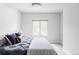 Bright bedroom features a cozy bed with blue accents and a view from the window offering a peaceful retreat at 2435 S High St, Denver, CO 80210