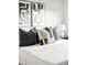 Bedroom features a comfortable bed with decorative pillows and stylish artwork creating a cozy and modern space at 2435 S High St, Denver, CO 80210
