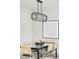 Dining area with glass table, designer light fixture, and modern art at 2435 S High St, Denver, CO 80210