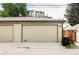 A two-car garage with modern design and attached residence above provides ample parking at 2435 S High St, Denver, CO 80210