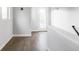 Hallway featuring gleaming hardwood floors with white walls and natural light at 2435 S High St, Denver, CO 80210