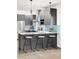 Modern kitchen with stainless steel appliances, ample counter space, and stylish barstool seating at 2435 S High St, Denver, CO 80210