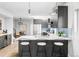 Modern kitchen features a sleek island with barstool seating and stainless steel appliances at 2435 S High St, Denver, CO 80210