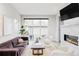 Bright living room features a sleek fireplace, large windows, and stylish, modern furniture at 2435 S High St, Denver, CO 80210