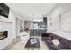 Open-concept living space with modern fireplace, seamlessly connecting to the kitchen at 2435 S High St, Denver, CO 80210
