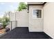 Private rooftop deck with dark tile flooring and wrought iron railing at 2435 S High St, Denver, CO 80210