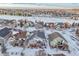 Aerial view of a snow-covered neighborhood with houses and a golf course at 23480 E Moraine Pl, Aurora, CO 80016