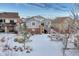 Snow covered backyard with a deck and stairs leading to the house at 23480 E Moraine Pl, Aurora, CO 80016