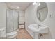 Basement bathroom with shower, pedestal sink, and toilet at 23480 E Moraine Pl, Aurora, CO 80016