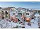 Two-story home with gray siding, brick accents, and a covered porch at 23480 E Moraine Pl, Aurora, CO 80016