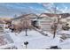 Front exterior view of a two-story home with mature trees and a snow covered yard at 23480 E Moraine Pl, Aurora, CO 80016
