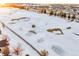 Aerial view of a snow-covered golf course with houses in the background at 23480 E Moraine Pl, Aurora, CO 80016