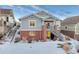 Two-story house exterior with gray siding and brick accents in winter setting at 23480 E Moraine Pl, Aurora, CO 80016