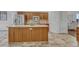 Kitchen island with wood cabinets and a light-colored countertop at 23480 E Moraine Pl, Aurora, CO 80016