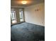 Bright living room featuring a blue carpet and large windows overlooking the city at 3131 E Alameda Ave # 604, Denver, CO 80209