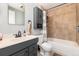 Bathroom with tiled shower/tub combo and gray vanity at 401 S Dover Ct, Lakewood, CO 80226