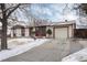 Ranch style home with attached garage and snowy front yard at 401 S Dover Ct, Lakewood, CO 80226