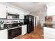 Stainless steel appliances and dark wood flooring in kitchen at 401 S Dover Ct, Lakewood, CO 80226