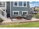 Inviting back patio with a charming barrel table, stylish seating, and space for entertaining outdoors at 12940 Brier Ct, Firestone, CO 80504