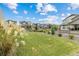 Expansive backyard featuring lush green grass, a well-manicured garden, and a serene outdoor space at 12940 Brier Ct, Firestone, CO 80504