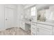Bright bathroom featuring dual sinks with quartz countertops, modern fixtures, and a glass-enclosed shower at 12940 Brier Ct, Firestone, CO 80504