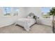 Comfortable bedroom with carpet flooring, two windows and a comfy bed with throw pillows at 12940 Brier Ct, Firestone, CO 80504
