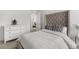 Cozy bedroom with a tufted headboard, decorative pillows, and a dresser at 12940 Brier Ct, Firestone, CO 80504