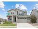 A charming two-story home boasting a covered porch, a two-car garage, and well-maintained landscaping at 12940 Brier Ct, Firestone, CO 80504