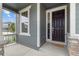 Close up of the front porch with a welcome mat and a glimpse of the neighborhood at 12940 Brier Ct, Firestone, CO 80504