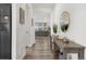 Bright and airy hallway featuring hardwood floors, neutral walls, and stylish decor at 12940 Brier Ct, Firestone, CO 80504