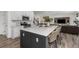 Open kitchen with a large island, bar stool seating, and stainless steel appliances at 12940 Brier Ct, Firestone, CO 80504