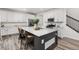Bright kitchen boasts a spacious island with seating and modern appliances at 12940 Brier Ct, Firestone, CO 80504