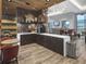 Coffee bar area with bar seating, TV, coffee machine and sink for community members at 12940 Brier Ct, Firestone, CO 80504