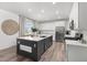 Modern kitchen features a large island, white cabinets, and stainless steel appliances at 12940 Brier Ct, Firestone, CO 80504