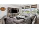 Inviting living room with comfortable gray sectional sofa and large entertainment center at 12940 Brier Ct, Firestone, CO 80504