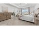 Serene main bedroom with tray ceiling, neutral tones, and ample natural light at 12940 Brier Ct, Firestone, CO 80504