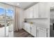 Butler's pantry with white cabinets, ample counter space, and natural light from sliding glass door at 12940 Brier Ct, Firestone, CO 80504