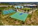 Enjoy recreational facilities with aerial view of tennis and basketball courts next to green space and community pool at 12940 Brier Ct, Firestone, CO 80504