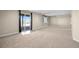 Finished basement with carpeting, recessed lighting and sliding glass door to the outside at 20670 Bridlewood Ln, Parker, CO 80138
