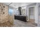 Primary bathroom features a glass enclosed shower, dual vanity and closet at 20670 Bridlewood Ln, Parker, CO 80138