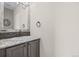 Bathroom with a vanity, granite countertop and decorative mirror and stone backsplash at 20670 Bridlewood Ln, Parker, CO 80138