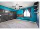 Bedroom with gray carpet, blue walls, and dark sliding closet doors at 20670 Bridlewood Ln, Parker, CO 80138