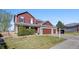 Two-story home featuring a three-car garage, a well-kept lawn, and a 'For Sale' sign at 20670 Bridlewood Ln, Parker, CO 80138