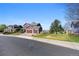 Street view of a two-story home with a three-car garage and a large front yard at 20670 Bridlewood Ln, Parker, CO 80138