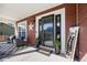 Welcoming front porch with seating area, stylish decor, and a glass front door at 20670 Bridlewood Ln, Parker, CO 80138