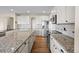 Elegant kitchen features white cabinetry, granite countertops, and stainless steel appliances at 20670 Bridlewood Ln, Parker, CO 80138