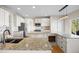 Gourmet kitchen with double islands, granite counters, stainless appliances and breakfast bar at 20670 Bridlewood Ln, Parker, CO 80138