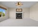 Living room with a fireplace, large window, neutral carpet and ceiling fan at 20670 Bridlewood Ln, Parker, CO 80138