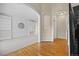 Open-concept living room with archways, white built-in shelves, and hardwood floors at 20670 Bridlewood Ln, Parker, CO 80138