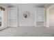 Bright living room features custom built-ins, modern wall decor, and neutral carpeting at 20670 Bridlewood Ln, Parker, CO 80138